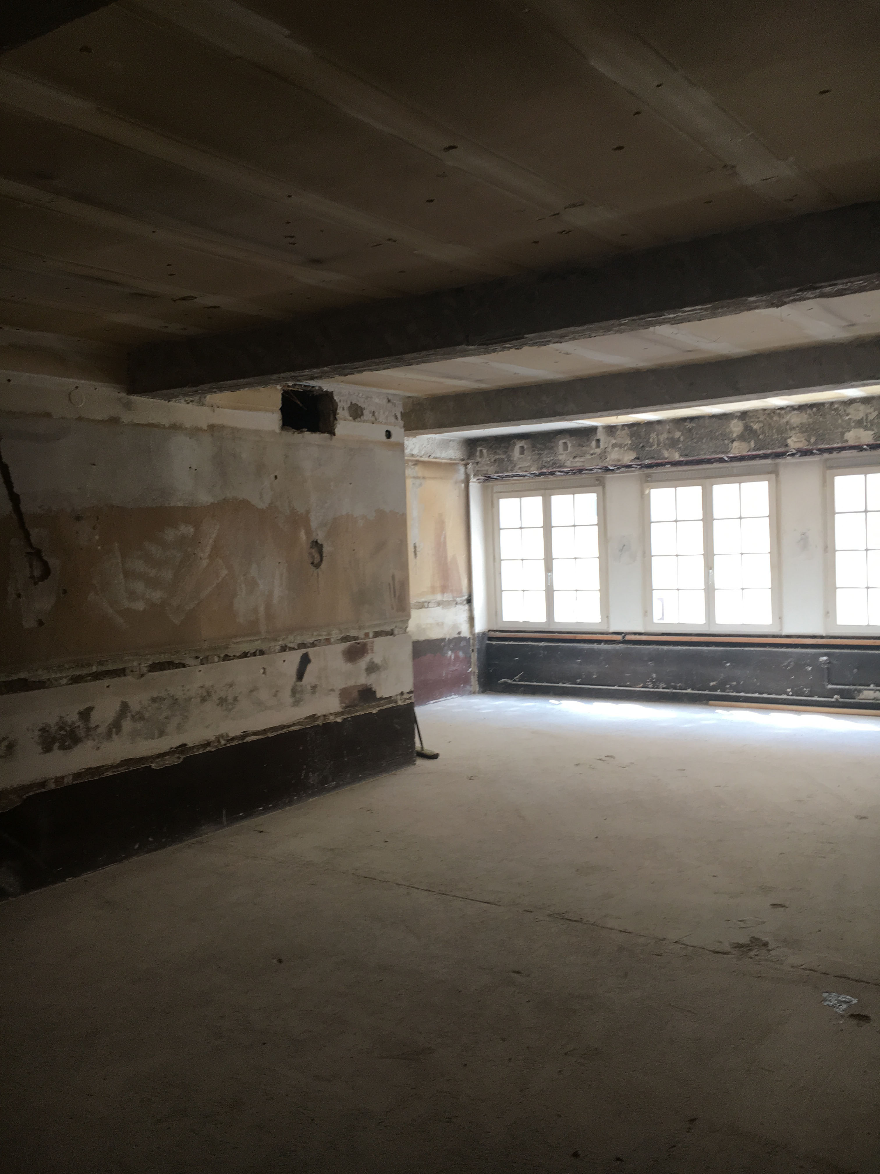 Apartment 8 before — raw shell looking toward window wall