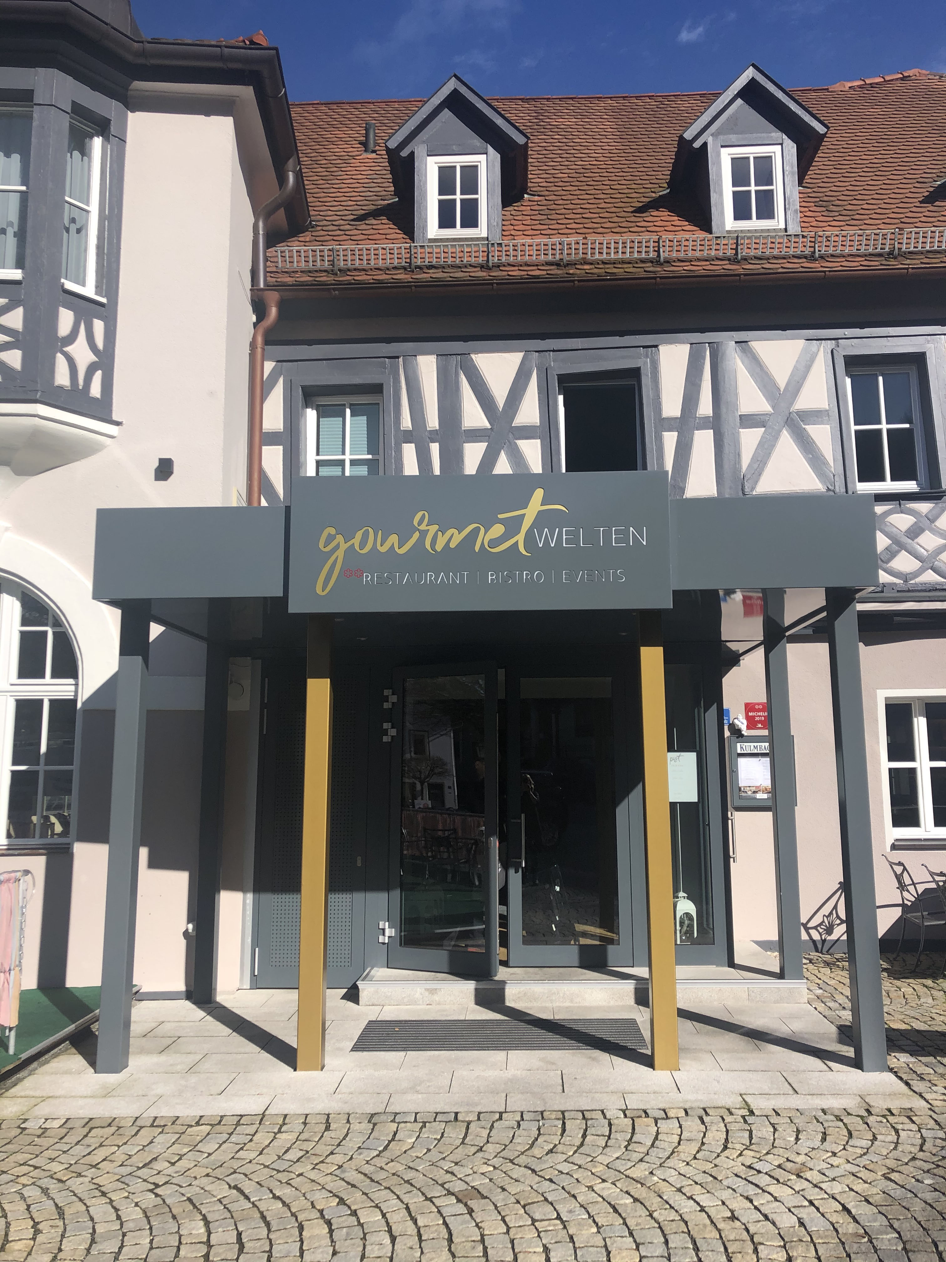Restaurant entrance after — Gourmet Welten, grey and gold