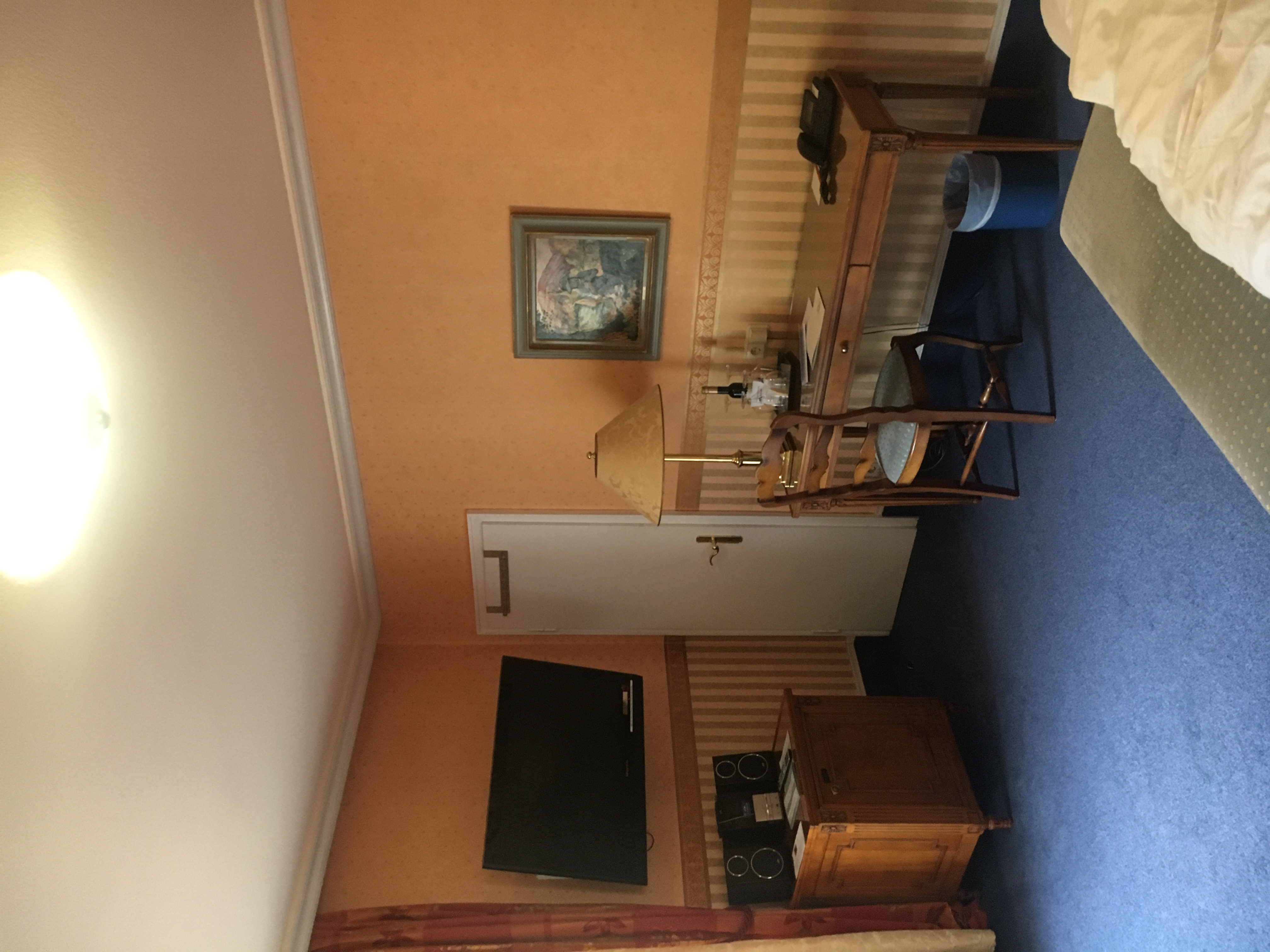 Hotel room before — orange walls, blue carpet