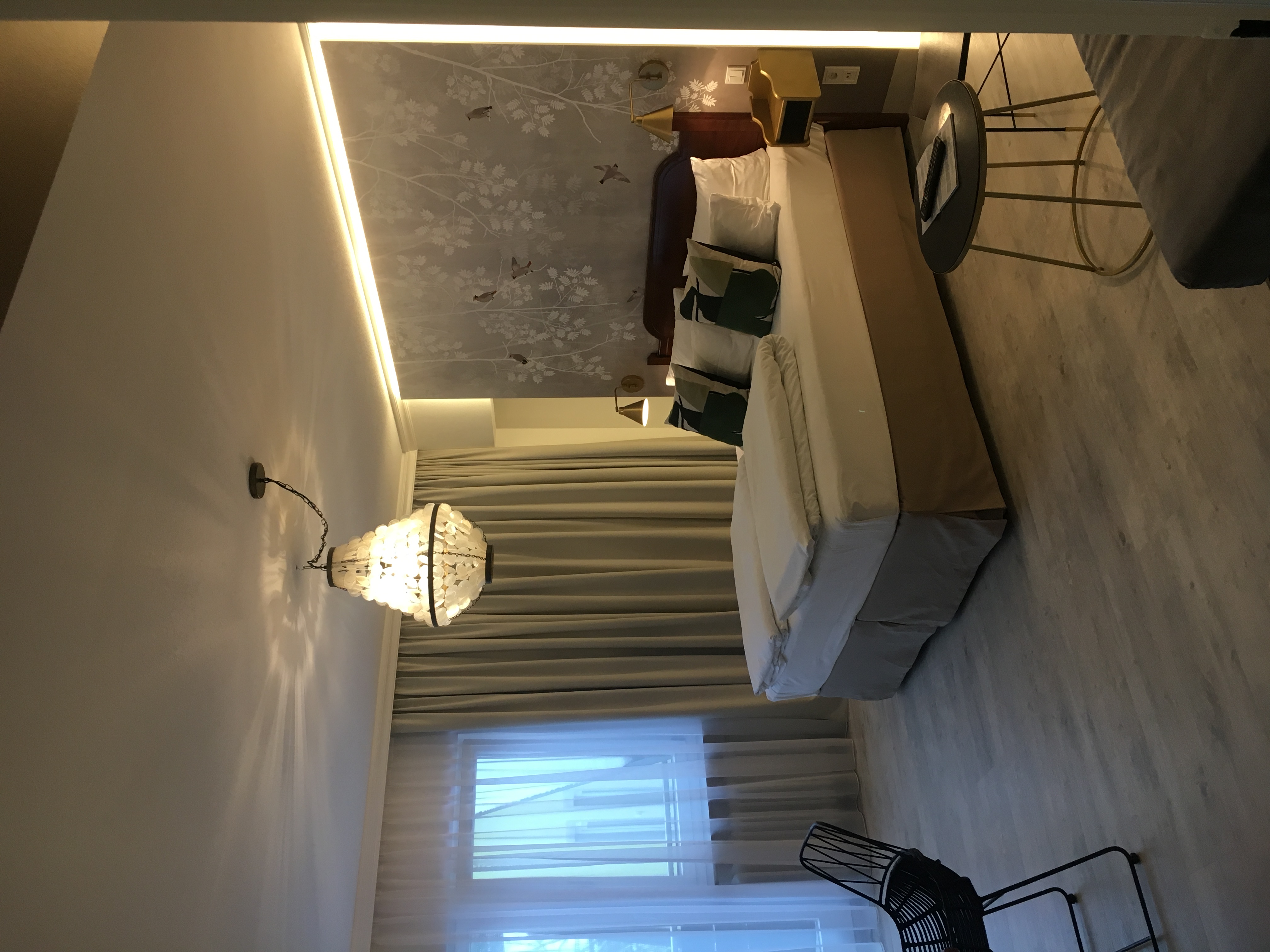 Bird wallpaper room — hotel chandelier reused