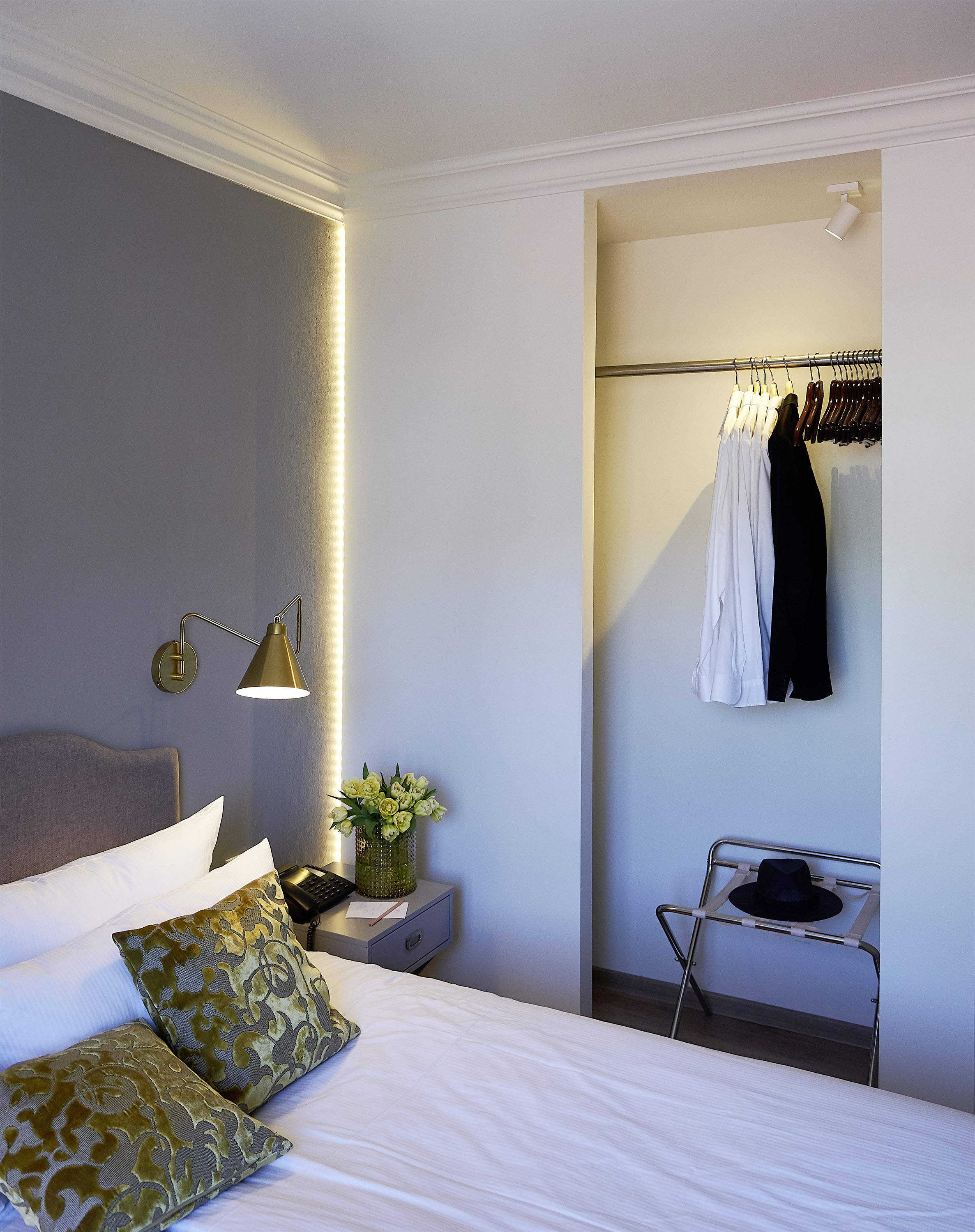 Grey-blue room — LED headboard niche, brass sconce