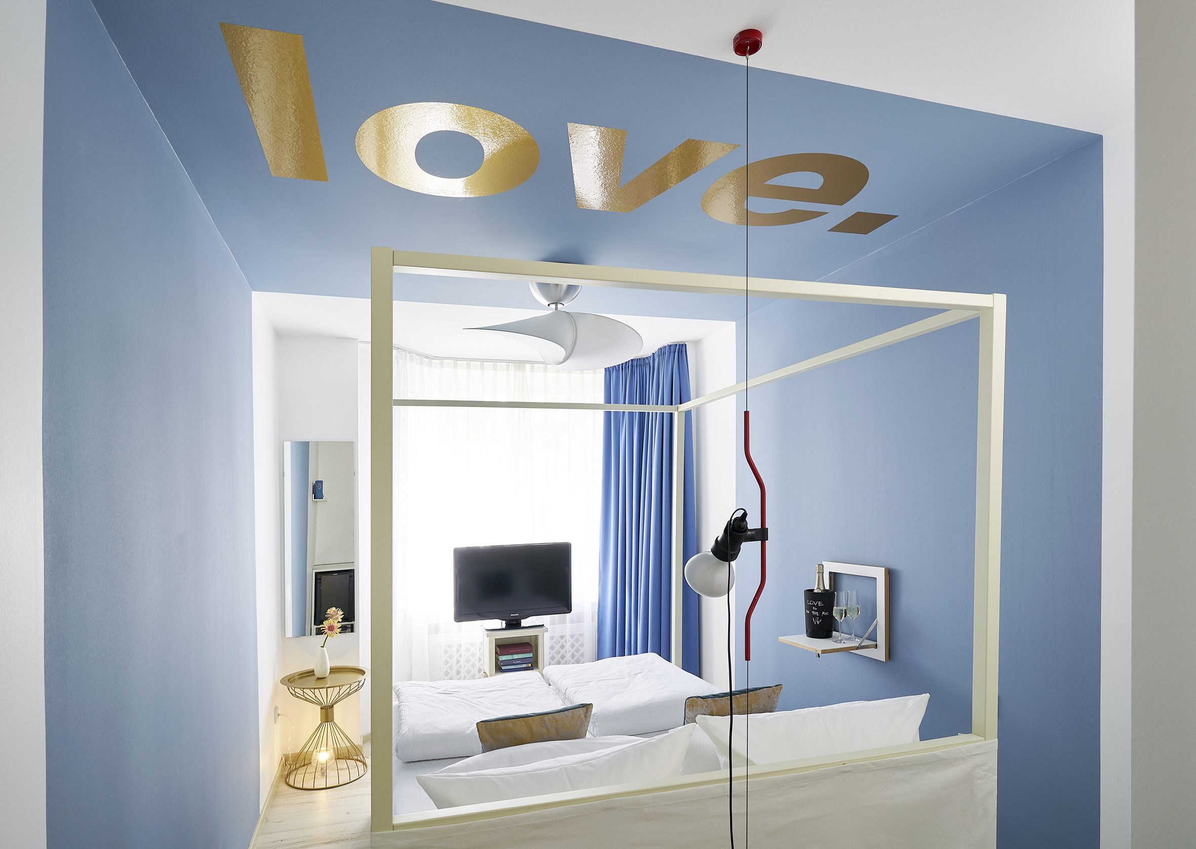 The Love room — gold typography on blue ceiling