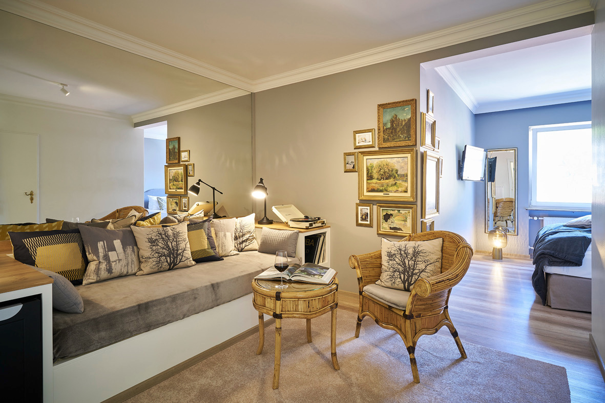 Suite — gallery wall, record player, sitting room through to bedroom
