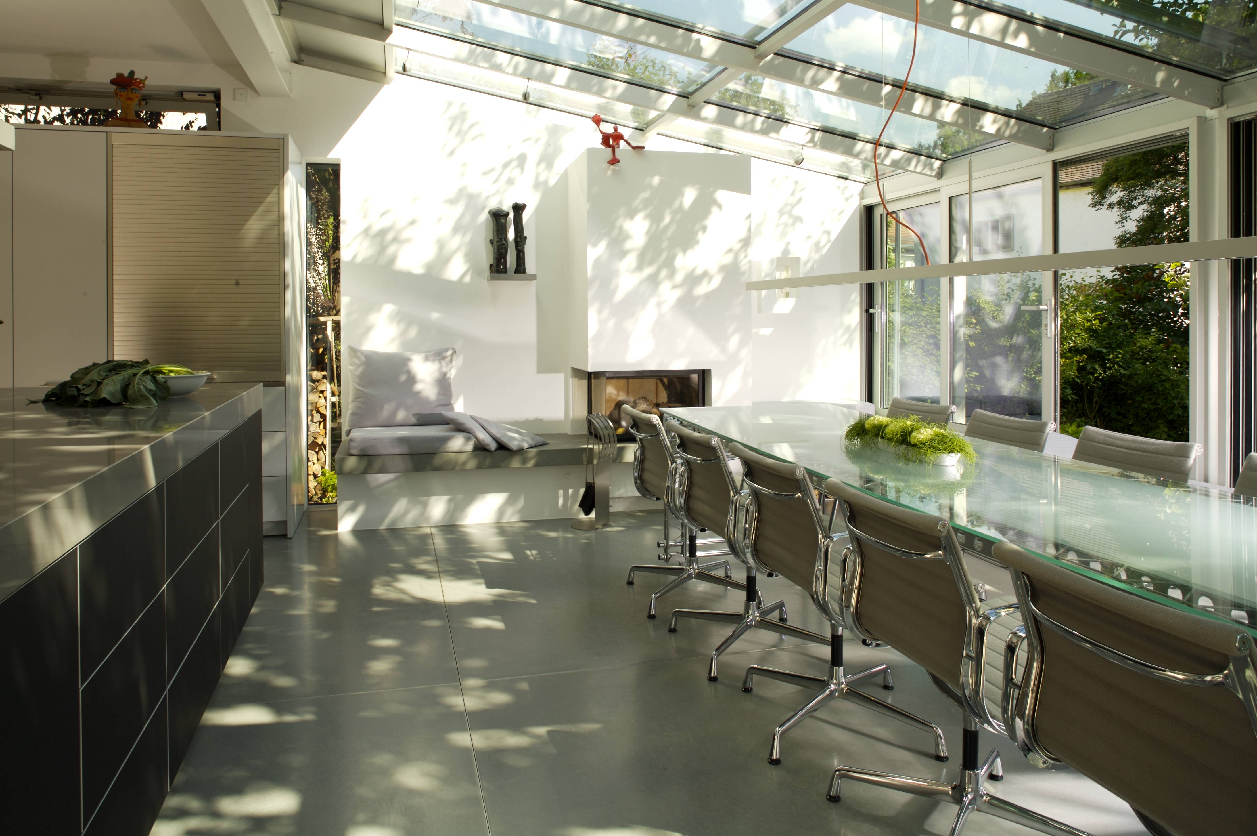 Full room — dining table, fireplace, glass roof, kitchen island