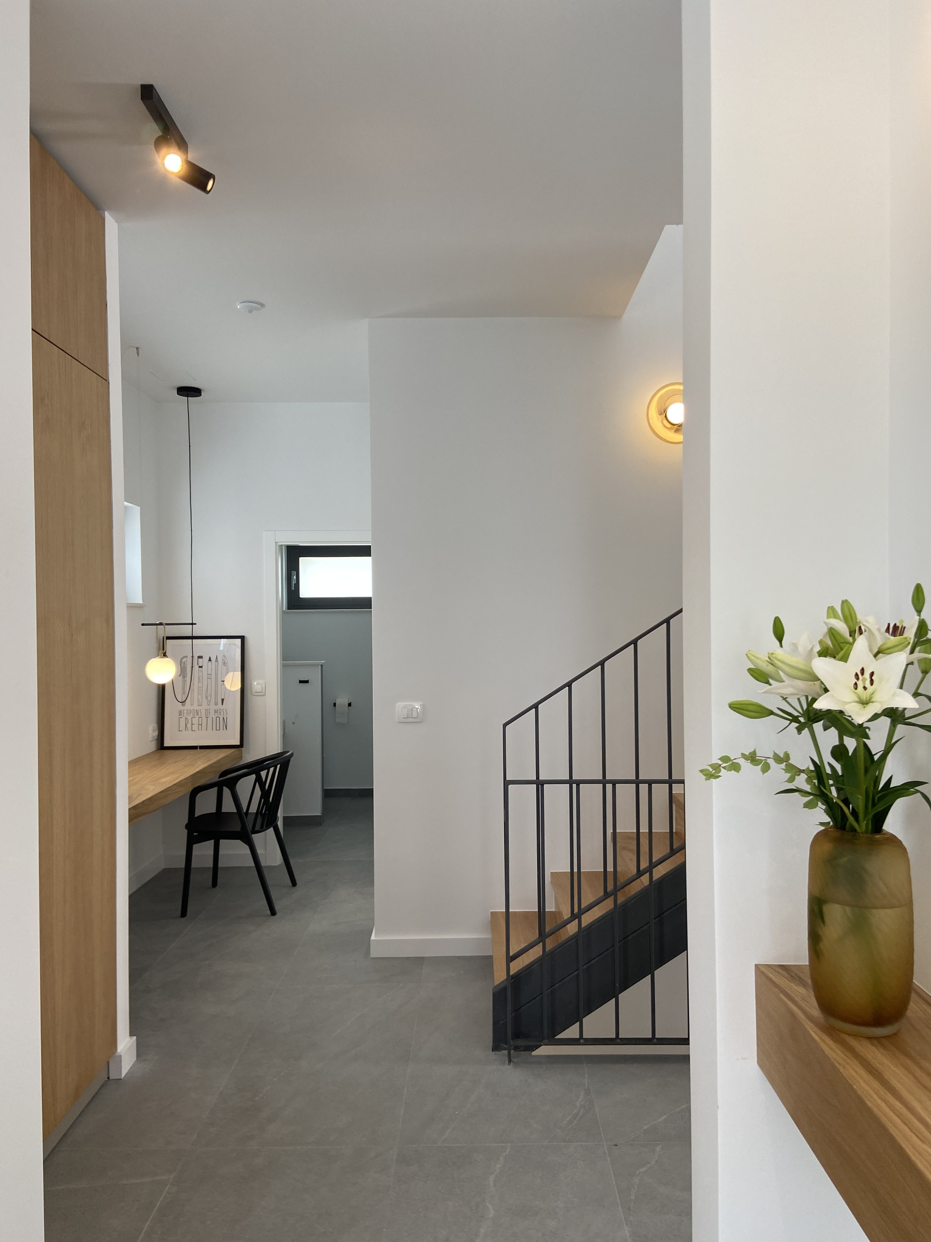 Entrance hallway — custom oak console, staircase, art