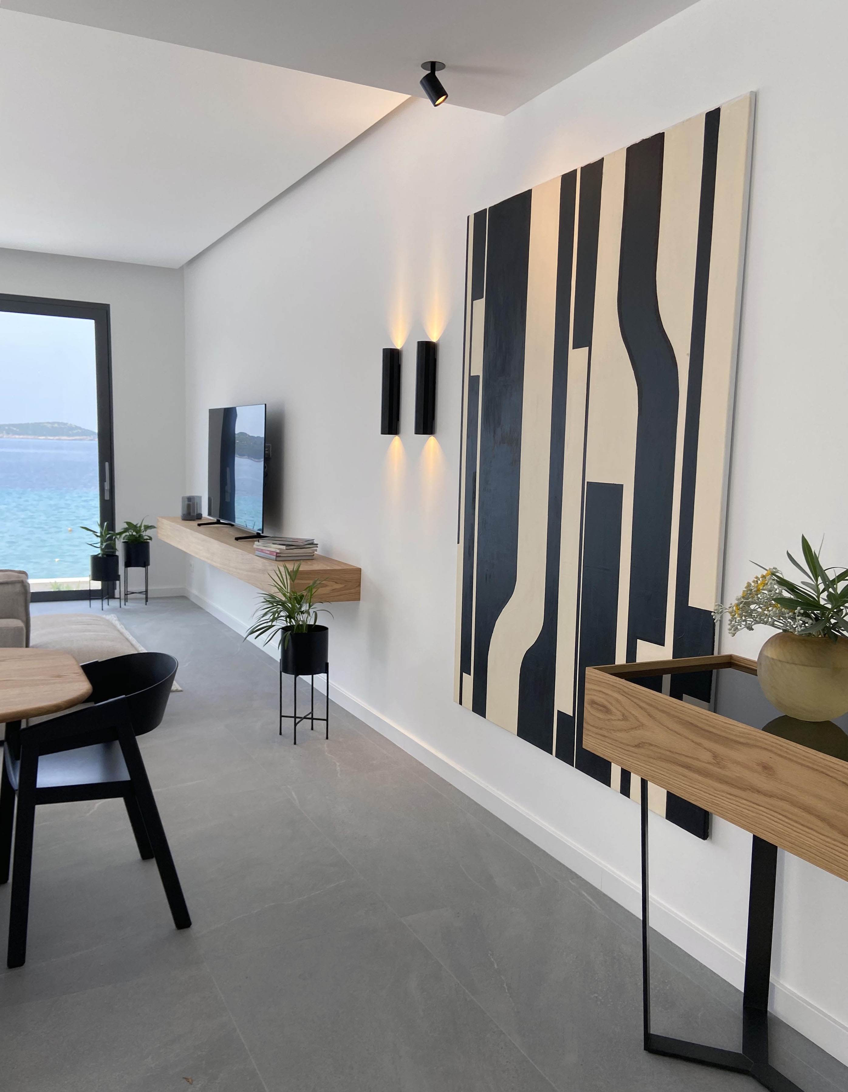 Living room with large format artwork and sea view